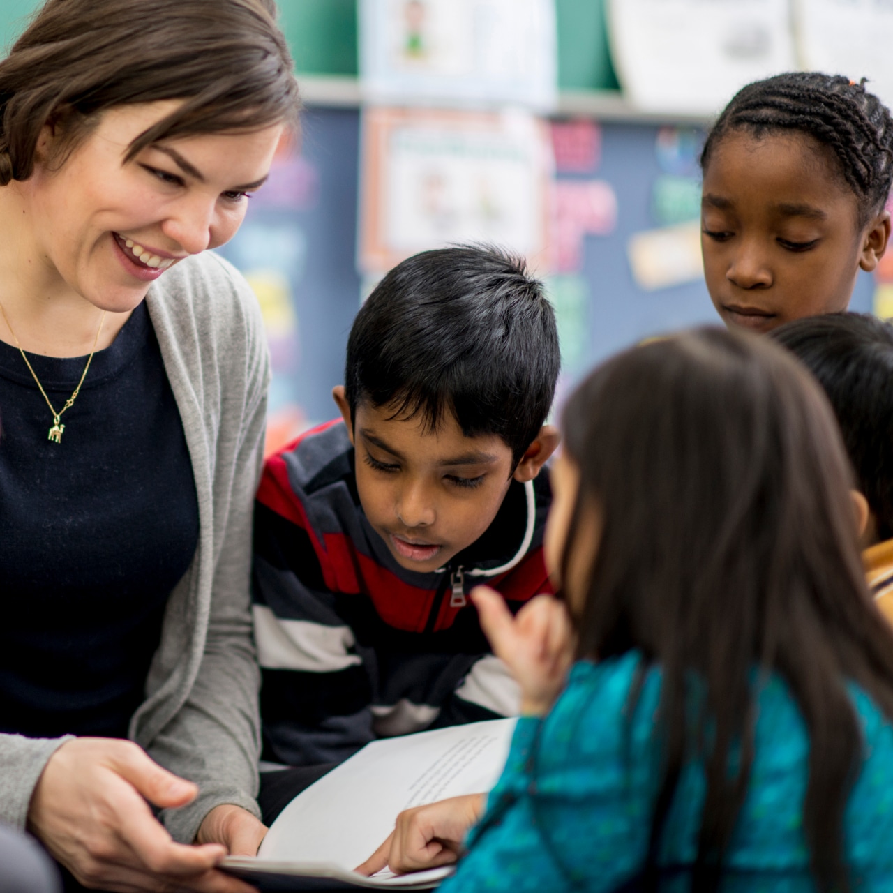Teacher reading to a group of young students
