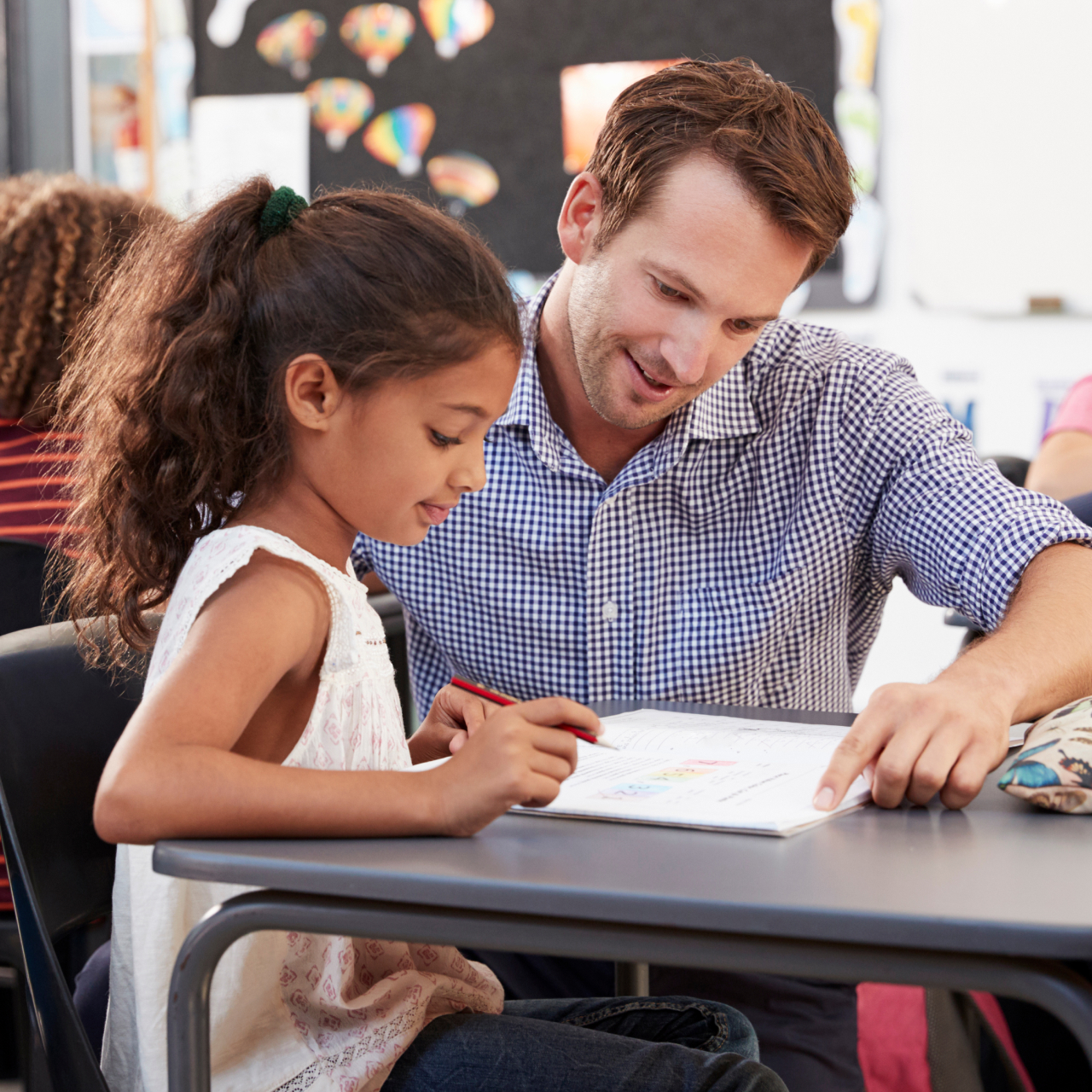 Teacher helping a young student